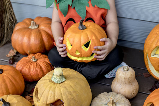 Little girl with Halloween pumpkins