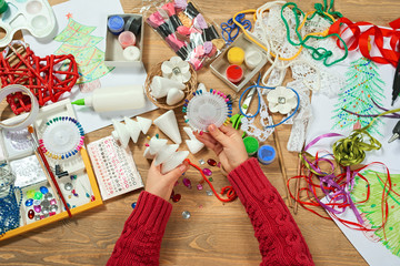 Childrens making decorations for new year holiday. Painting watercolors. Top view. Artwork...