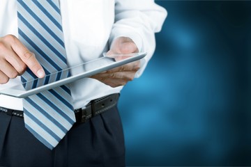Businessman with personal  tablet pc on background