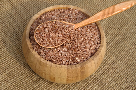 Uzbek red rice for cooking pilaf - devzira in a bamboo bowl