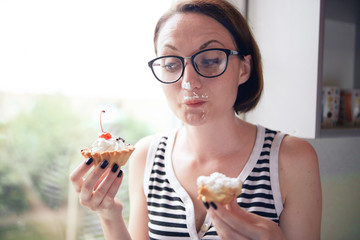 girl eating tasty cakes, sitting by the window, sweet food and pleasure