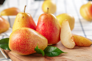 organic pears laying down on a lightly dotted kitchen cloth