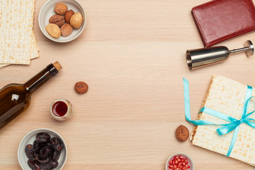 Jewish holiday Passover banner design with wine, matzo  on wooden background. View from above. Flat lay