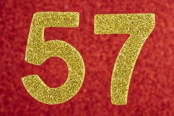 Number fifty-seven gold color over a red background. Anniversary