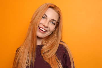 Fototapeta premium Beautiful young woman on color background