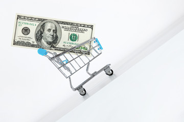 Hundred dollar bill in cart. Rising up direction with red arrow sign. Growth of wealth concept....