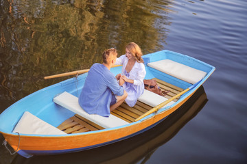 Cute young couple having romantic date in boat