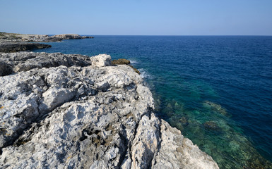 Puglia, Italy, the rocks and the limpid water sea of the north coast of San Domino island on a sunny summer day
