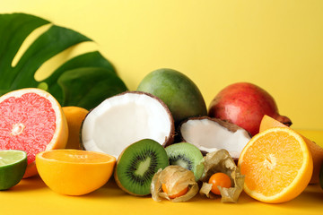 Various delicious exotic fruits on color background