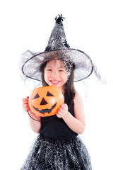 little asian girl wearing witch costume for Halloween holding pumpkin bucket isolated over white...