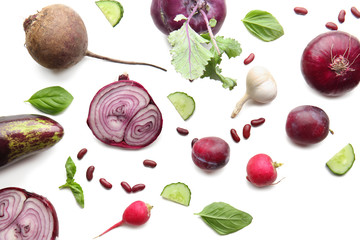Flat lay composition with various vegetables and plums on white background