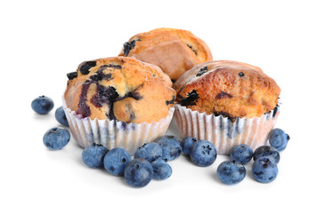 Tasty blueberry muffins on white background