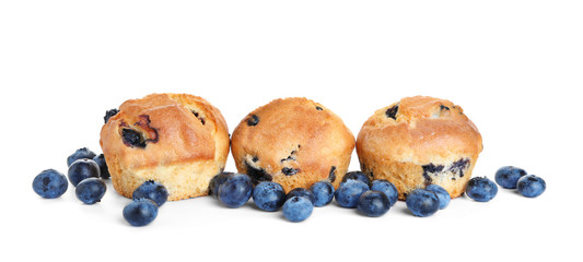 Tasty blueberry muffins on white background