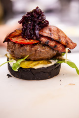 Chef performs how to make proper buger. Delicious food