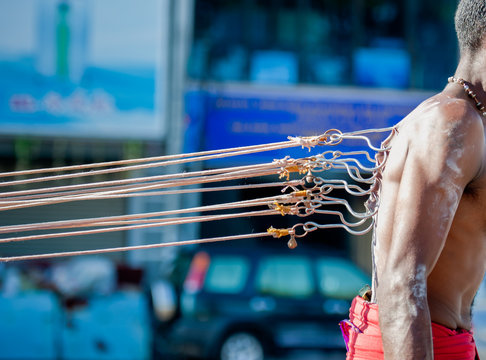 Thaipusam devotee in Penang pierce their backs with large hooks in penance