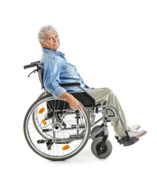 Obraz na płótnie Canvas Senior woman in wheelchair on white background