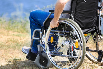 Obraz premium Senior man in wheelchair near river