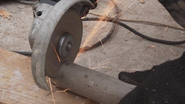 Electric circular saw cuts off metal pipe stock footage video