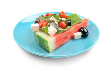 Plate with slice of watermelon and tasty salad on white background