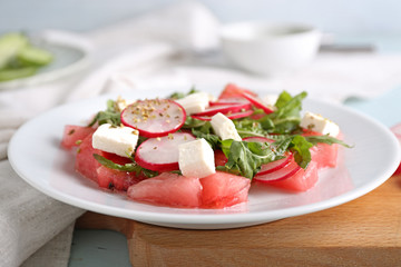 Plate with delicious watermelon salad on table, closeup