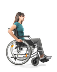 Obraz na płótnie Canvas Young woman in wheelchair on white background