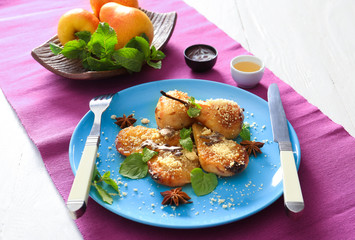Plate with baked pears on table