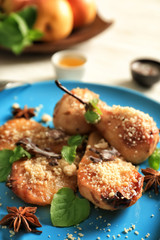 Baked pears with nuts on plate, closeup