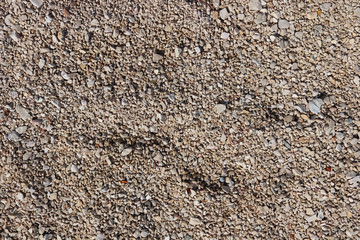 Fine pebbles of a brown shade. Beach ground. Natural material for design, decoration and construction. Sanded granite and hard minerals. Geology and minerals. Tutorial.