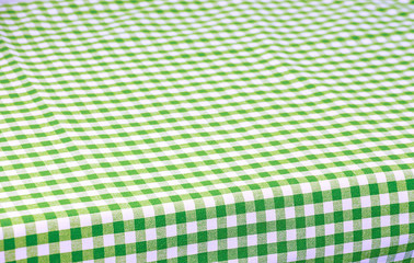 
Green tablecloth in a cage isolated on a white background