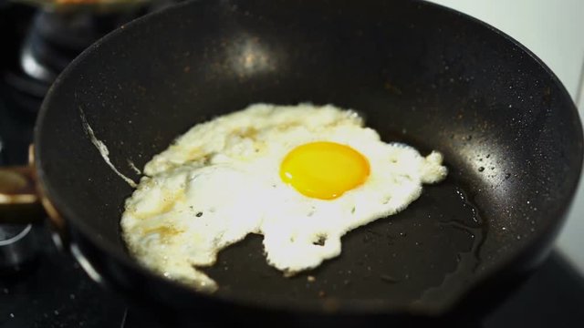 slow-motion of fried egg on pan