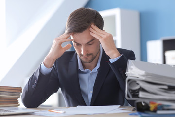 Tired businessman working in office