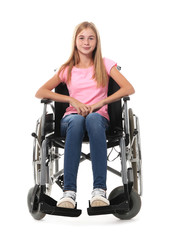 Teenage girl in wheelchair on white background