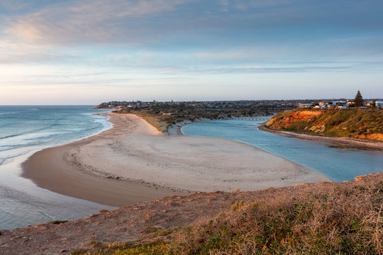 A golden Sunset over the Onkaparinga River mouth looking north towards the Port Noarlunga Jetty in South Australia on 23rd September 2018
