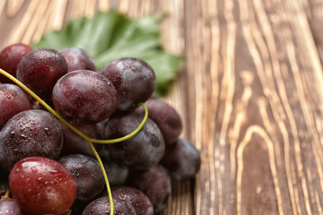 Ripe sweet grapes on wooden table, closeup