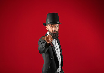 Male magician on color background
