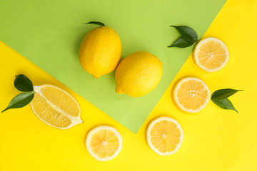 Flat lay composition with ripe juicy lemons on color background