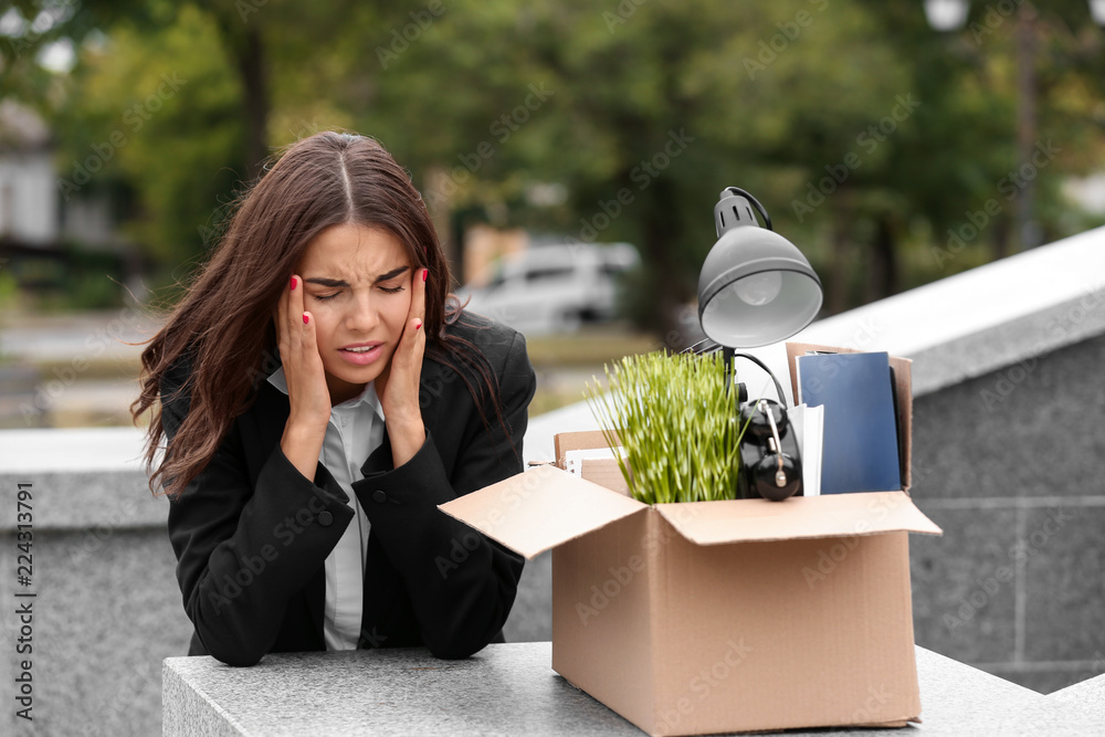 Sticker Fired stressed worker with personal stuff suffering from headache outdoors