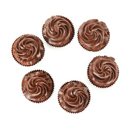 Tasty chocolate cupcakes on white background, top view