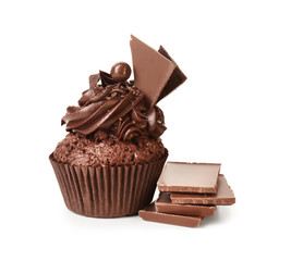 Tasty cupcake and pieces of chocolate bar on white background