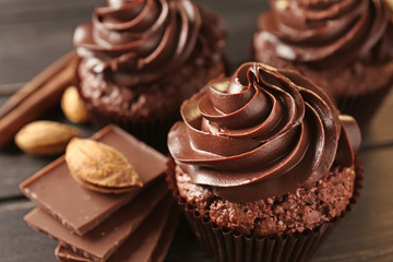 Tasty chocolate cupcakes on wooden table, closeup