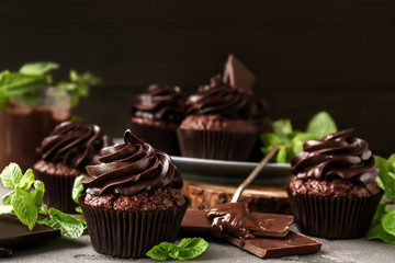 Tasty chocolate cupcakes on table