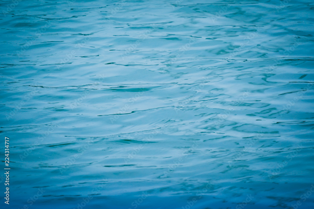 Wall mural blue water surface background texture blurred light with wave ripple nature abstract.