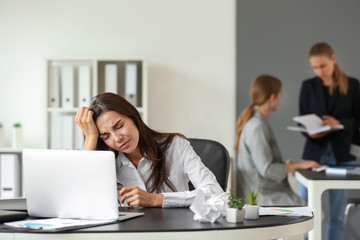 Tired businesswoman working in office