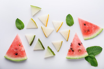 Summer composition with slices of melon and watermelon on white background
