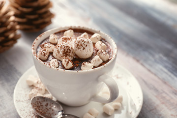 Cup of hot chocolate with marshmallows on table