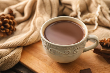 Cup of hot chocolate on wooden board