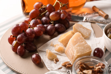 Fresh ripe juicy grapes with cheese on table