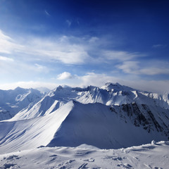 Fototapeta na wymiar Snowy mountains and sunlight sky