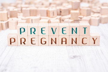 The Words Prevent Pregnancy Formed By Wooden Blocks On A White Table