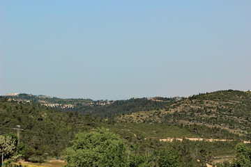 Fototapeta na wymiar Green mountains with settlements near Jerusalem, Israel